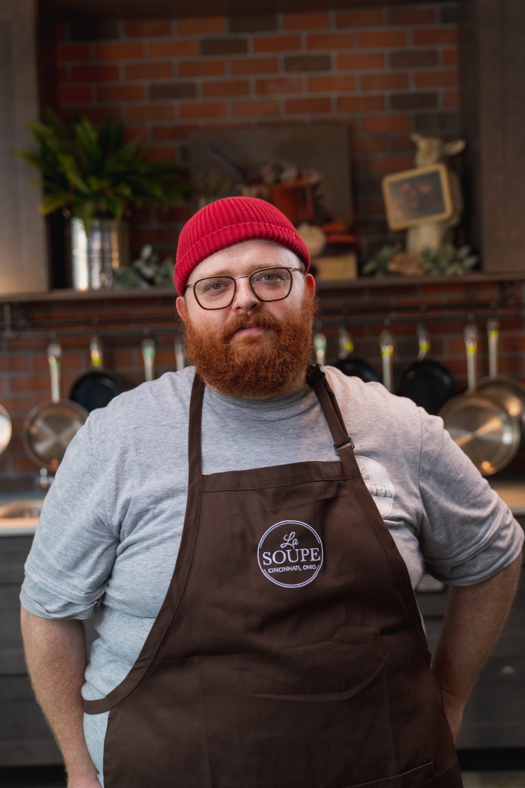 Chef in an apron standing in a commercial kitchen
