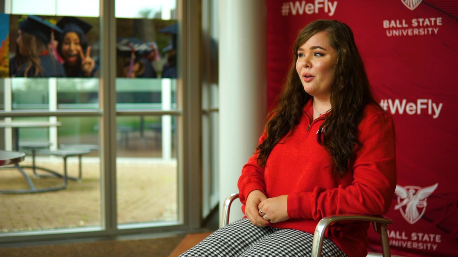 Student interviewed by a window