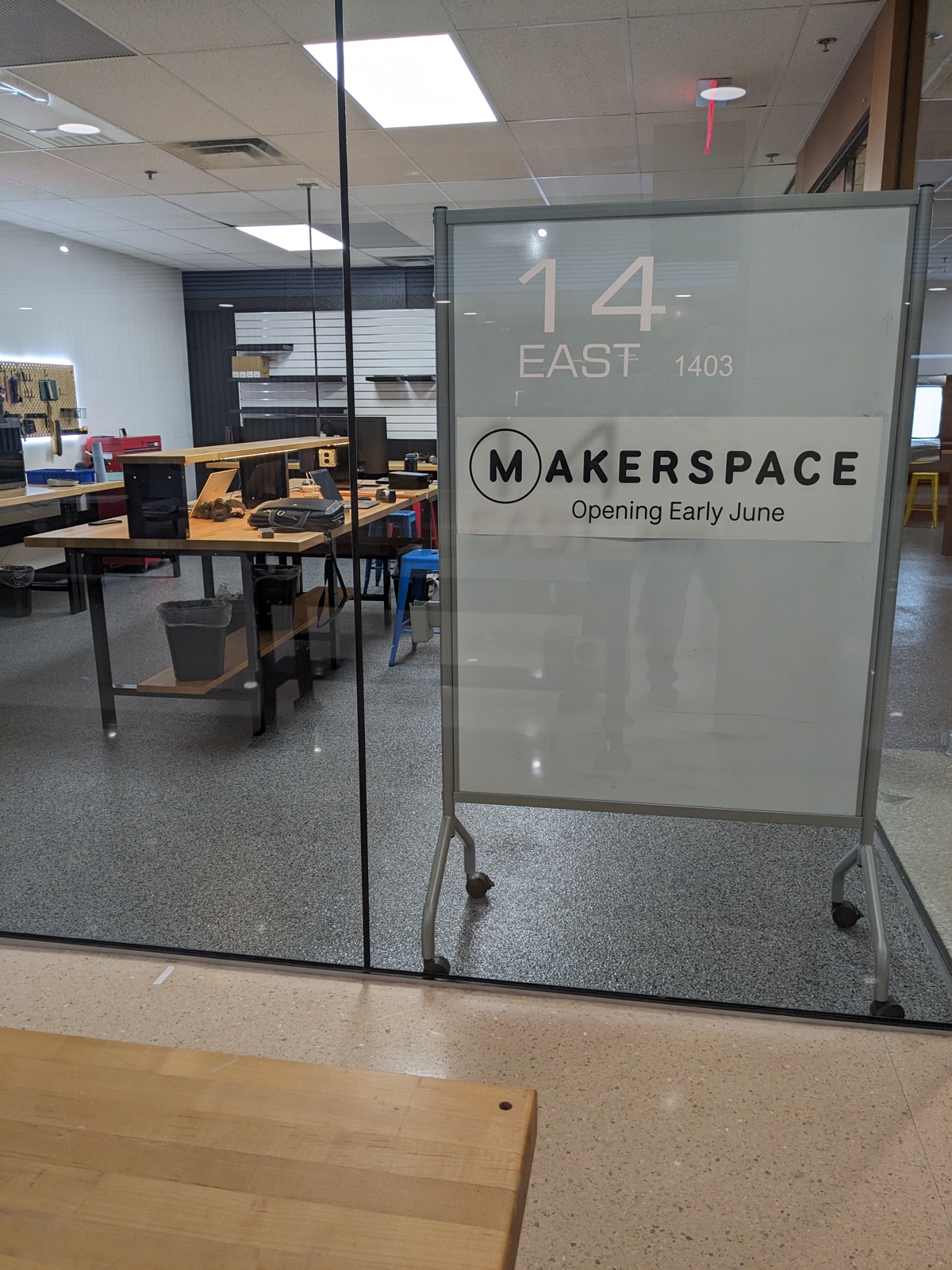 “Opening early June” sign inside the glass wall of the new Makerspace