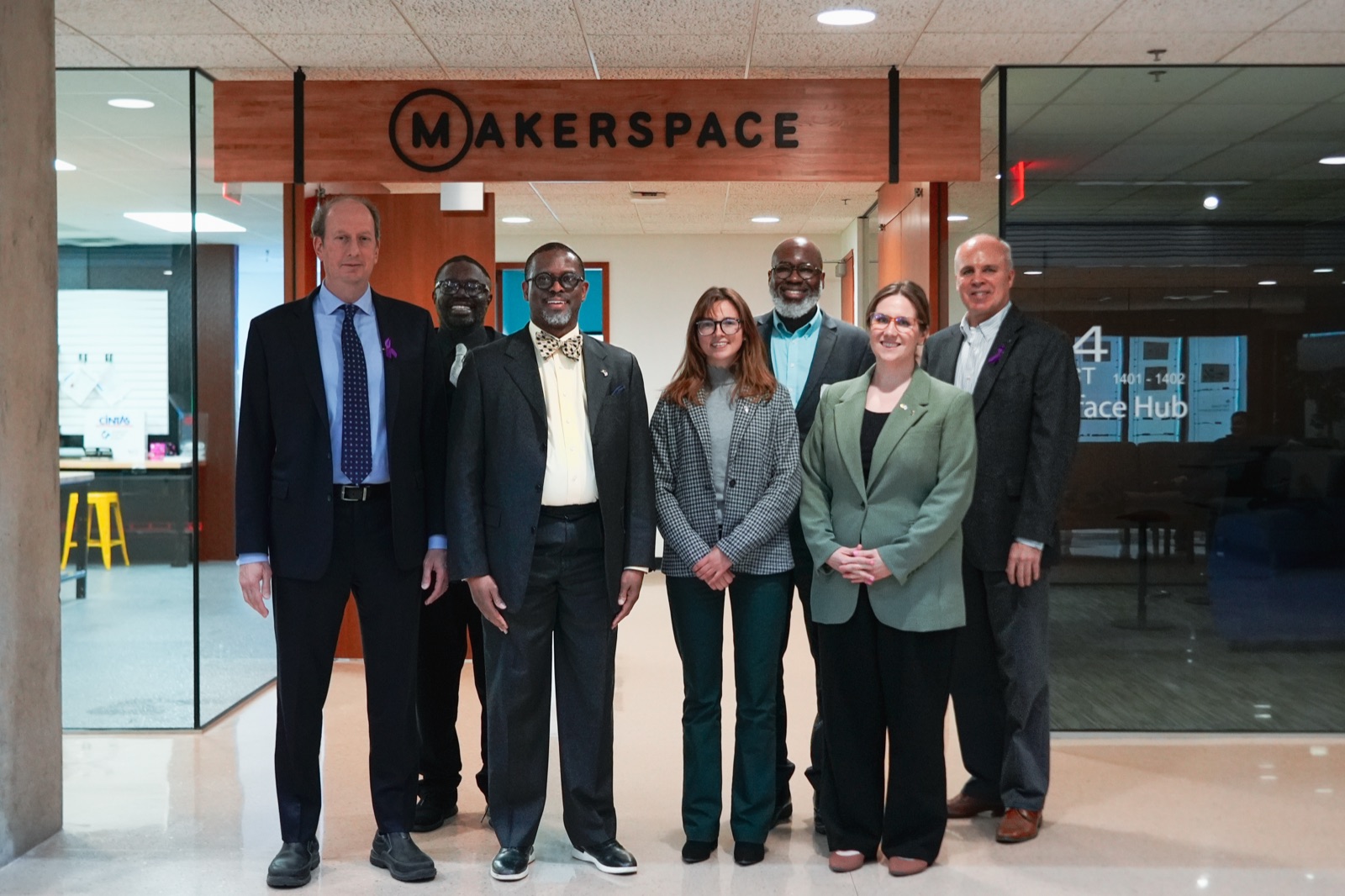 Visiting group posed at the Makerspace entrance