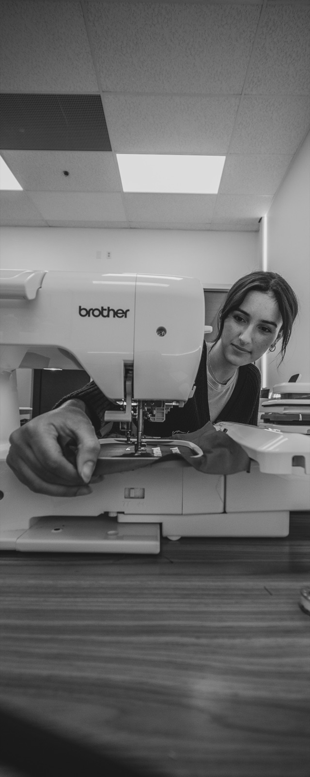 Black and white photo of a maker at the banner printer