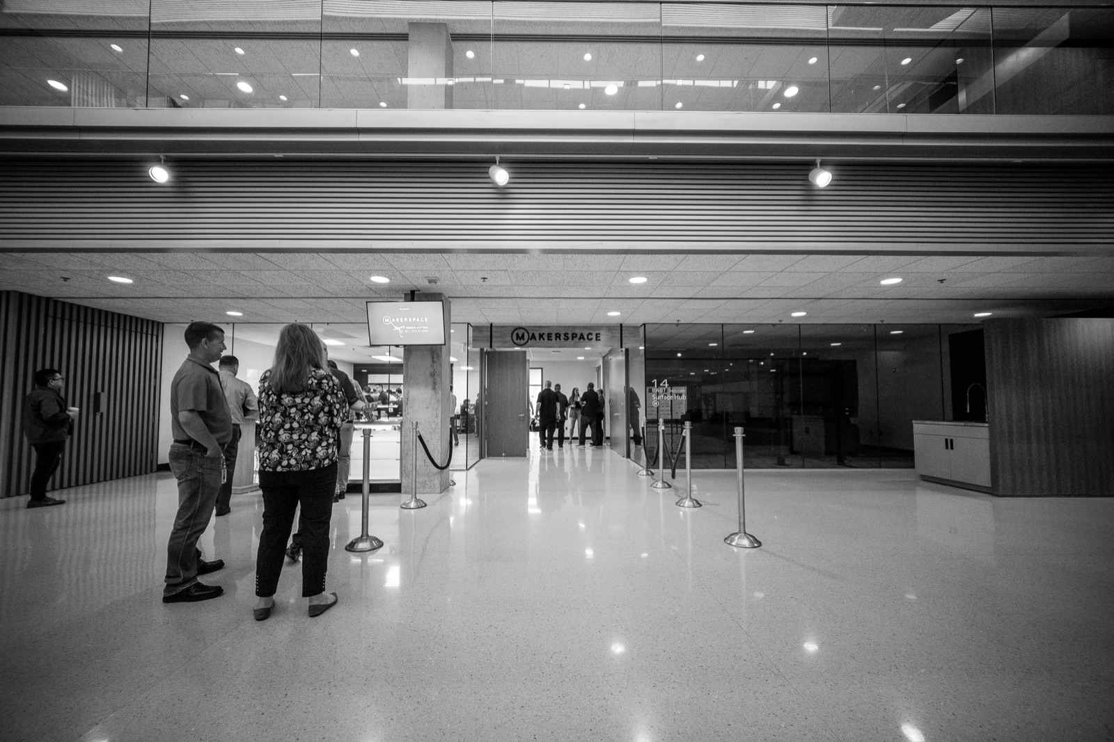 Black and white view of guests arriving in the hallway