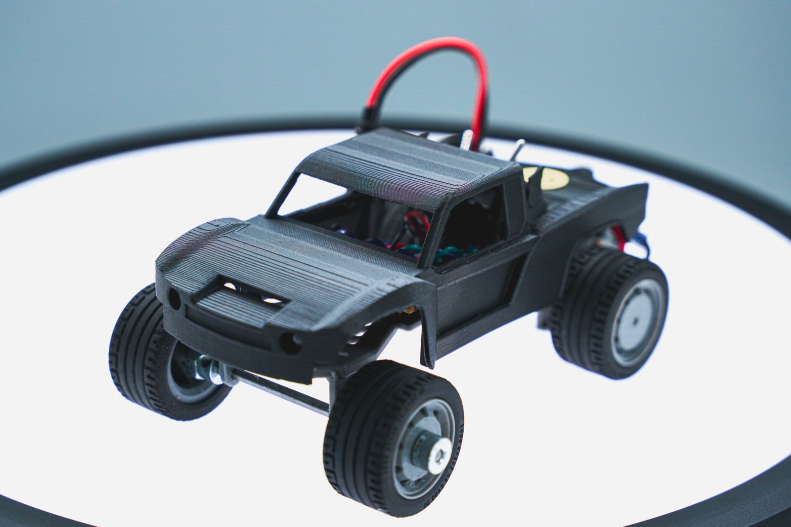 Small black electric vehicle on a white sweep